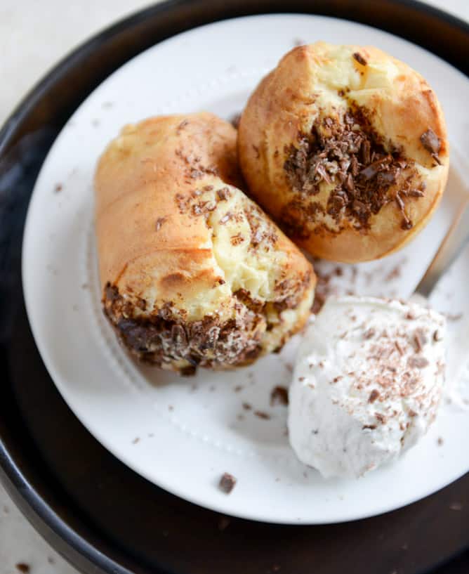 Dark Chocolate Chunk Popovers with Spiked Vanilla Bourbon Whipped Cream I howsweeteats.com Dark Chocolate Chunk Popovers with Spiked Vanilla Bourbon Whipped Cream I howsweeteats.com