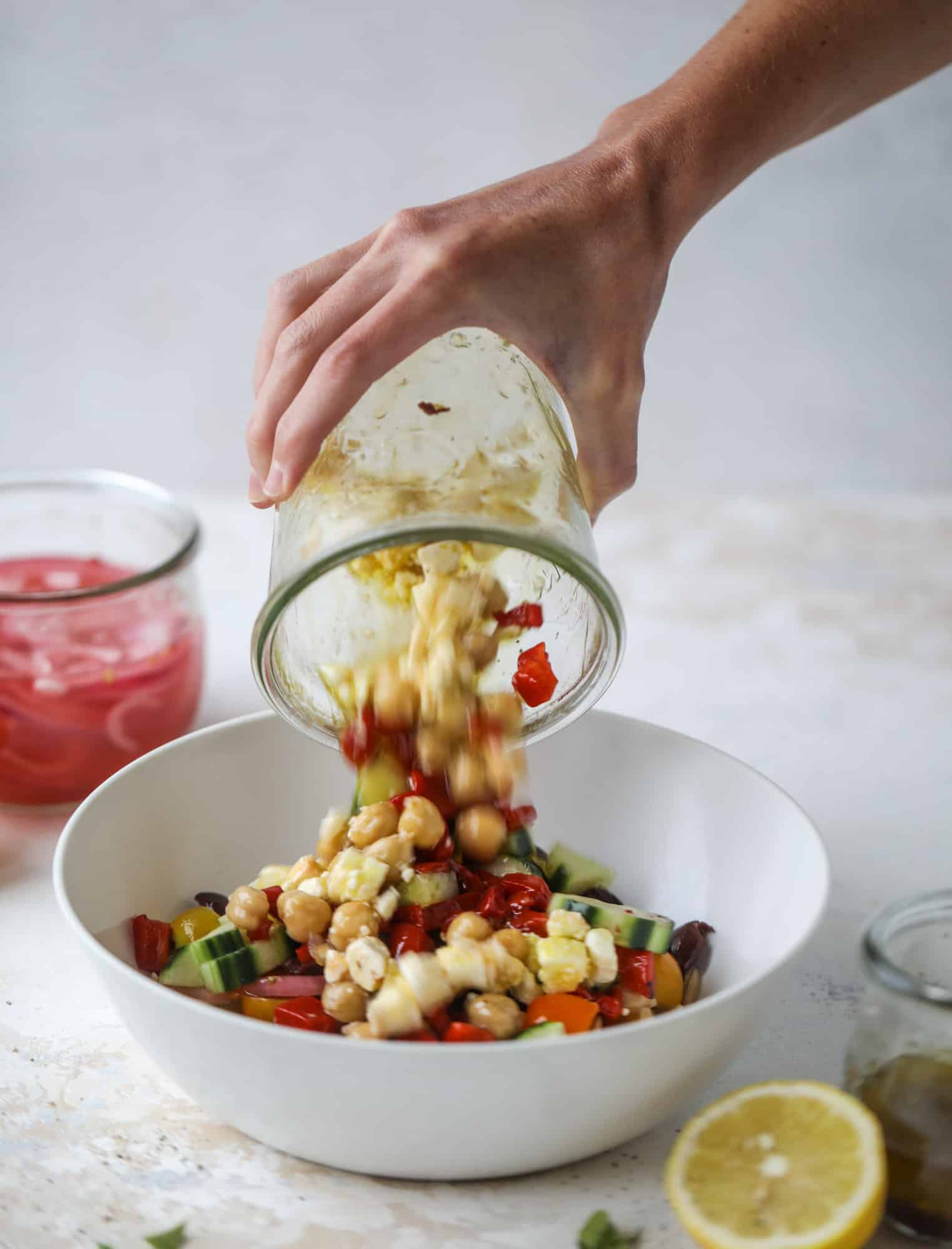 This incredible greek orzo salad in a jar is to die for! The recipe is so easy and flavorful, super satisfying and perfect for meal prep. This salad in a jar is a delicious lunch idea for the weekdays and keeps you feeling full and happy! I howsweeteats.com #salad #jar #greek #orzo #recipes #healthy #lunch #mealprep
