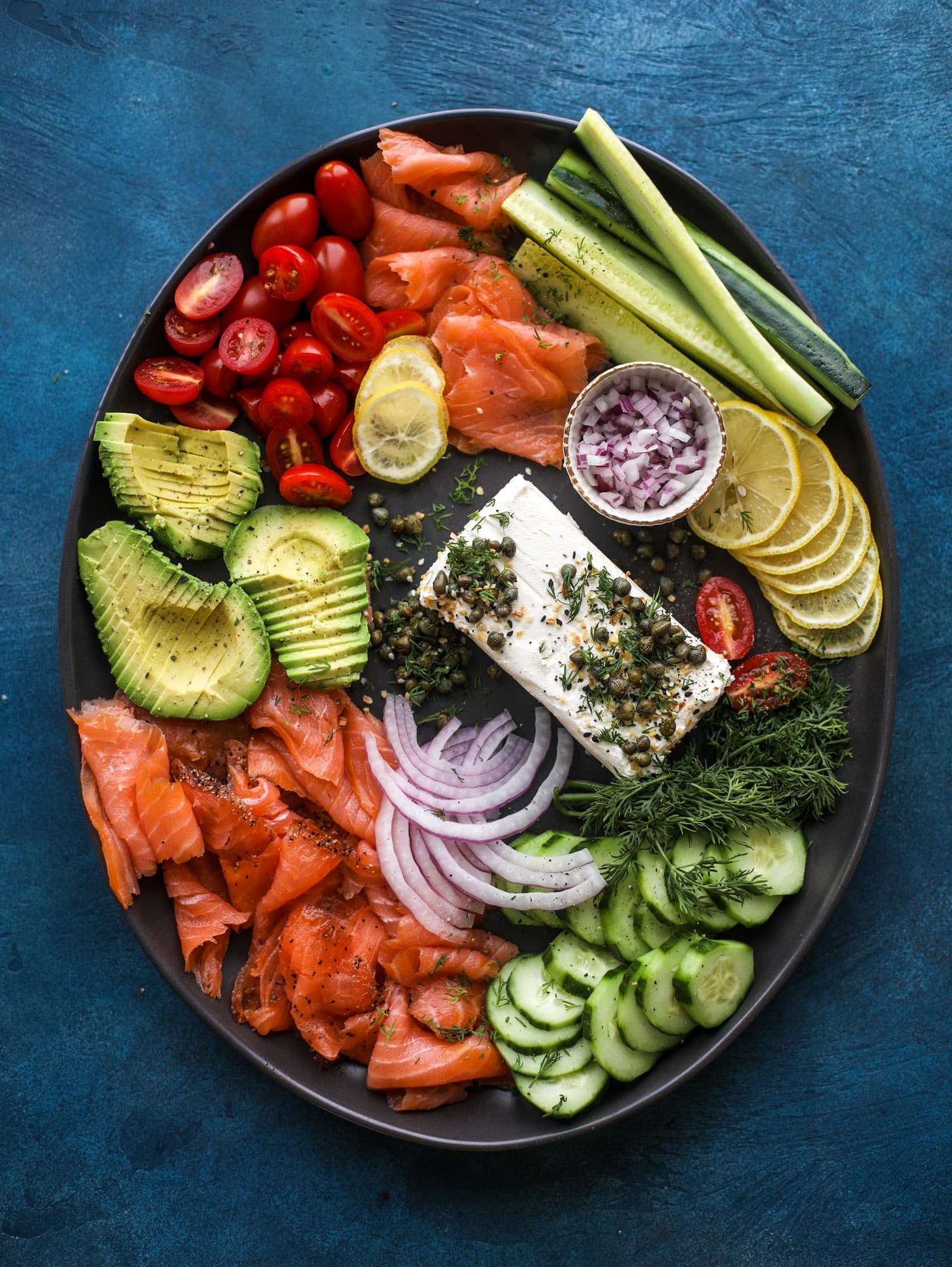 This is my favorite way to make an incredible smoked salmon platter! Fresh smoked salmon with bagels, soft boiled eggs, cream cheese and capers, everything seasoning and so much more. Perfect for holiday breakfasts and brunches! I howsweeteats.com #smokedsalmon #platter