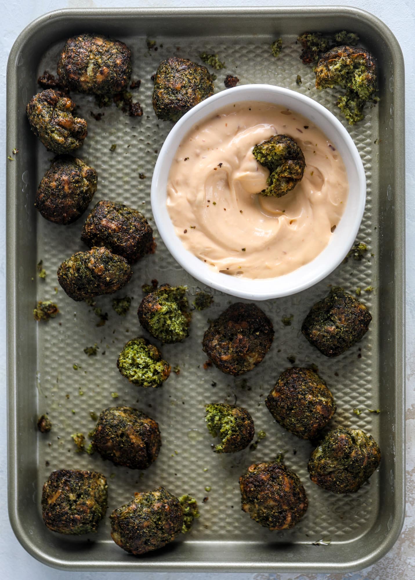 These broccoli cheddar tots are baked, crispy bites of broccoli and sharp cheddar cheese! So delicious and easy to throw together too. I howsweeteats.com #broccolicheddar #tots