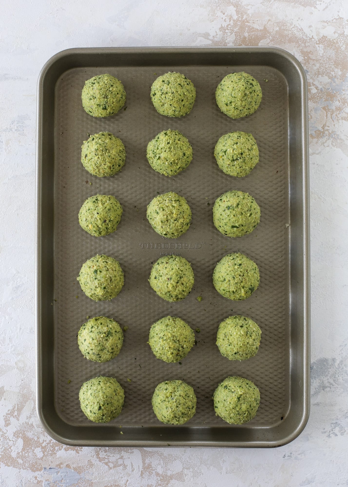 Green goddess falafel is hearty and flavorful, served over the creamiest cauliflower hummus, with tomatoes, olive, cucumbers and feta. Yum! I howsweeteats.com #falafel #cauliflowerhummus