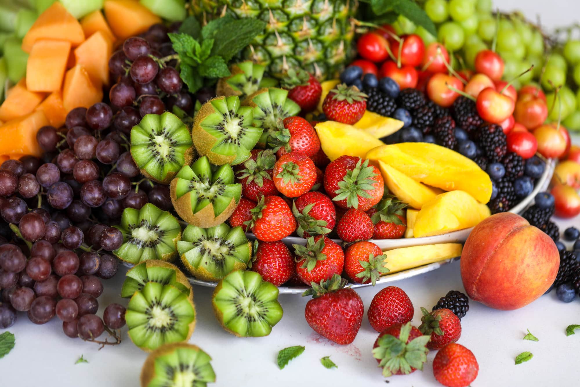 This is the cutest way to display fruit! A pineapple palm tree fruit tray will be the star of the show at your next summer BBQ or party!