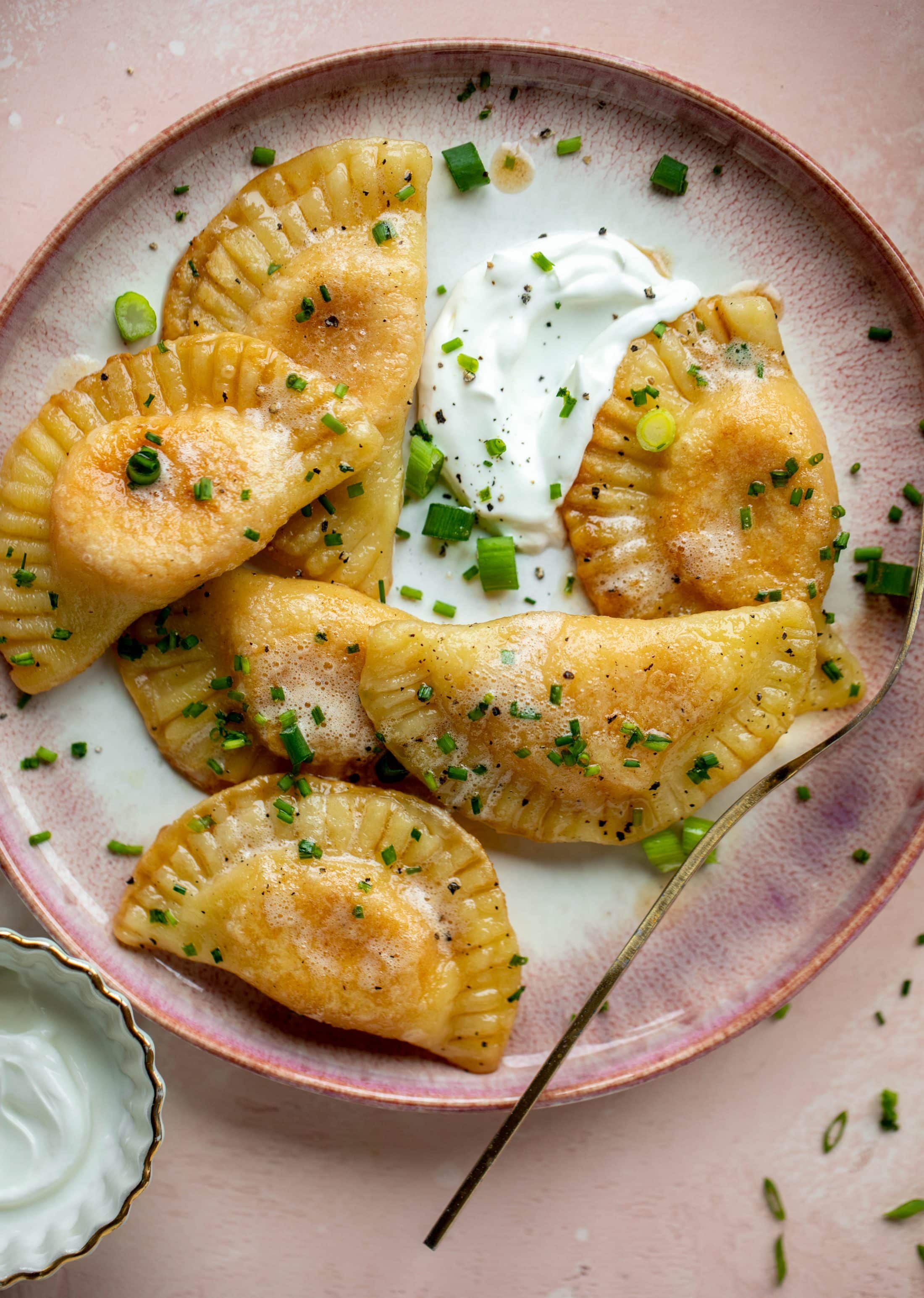 The most delicious sweet potato pierogi recipe! Roasted sweet potato and fontina cheese in pillowy dough. Make sure to serve with brown butter!