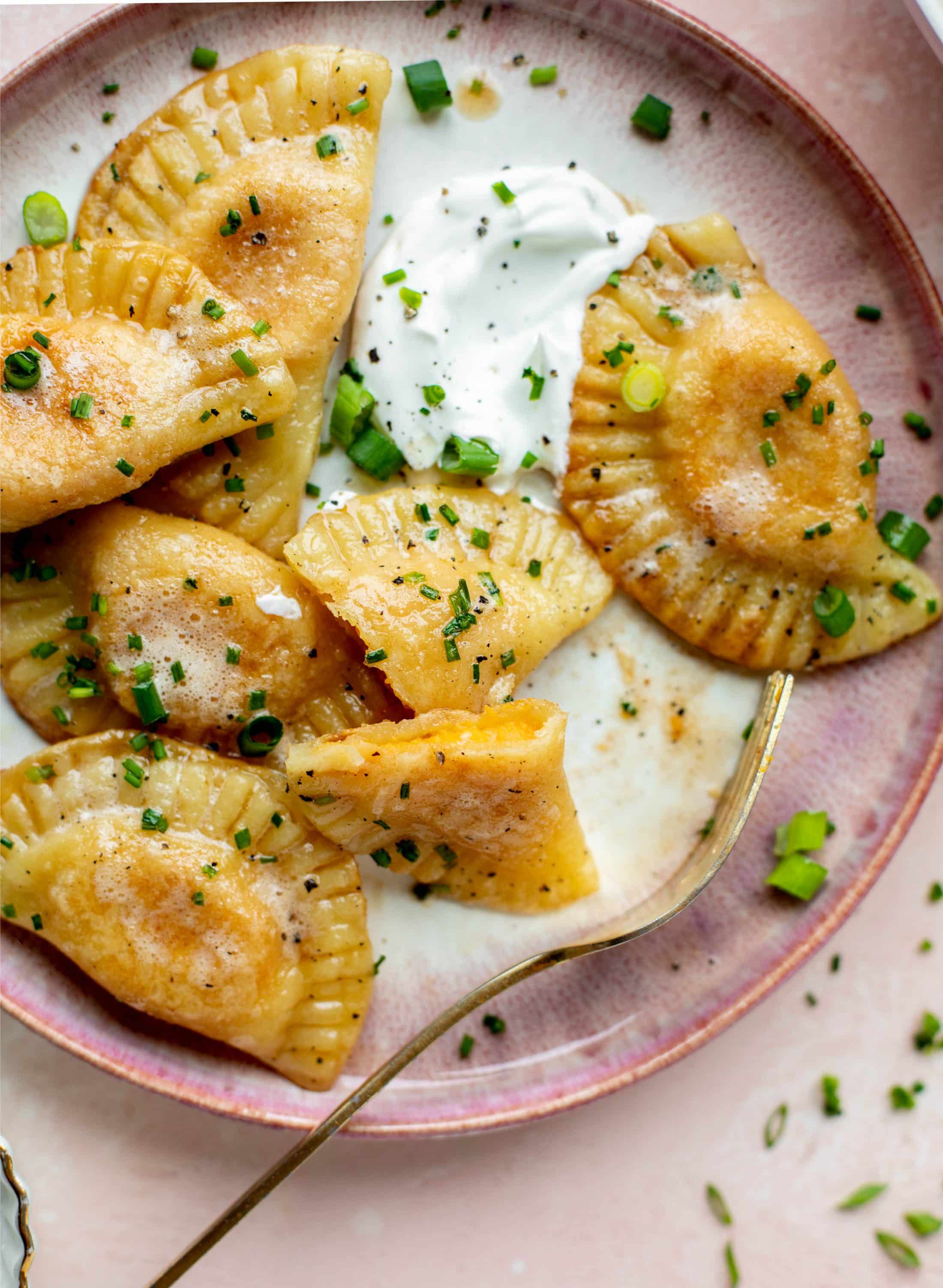 The most delicious sweet potato pierogi recipe! Roasted sweet potato and fontina cheese in pillowy dough. Make sure to serve with brown butter!