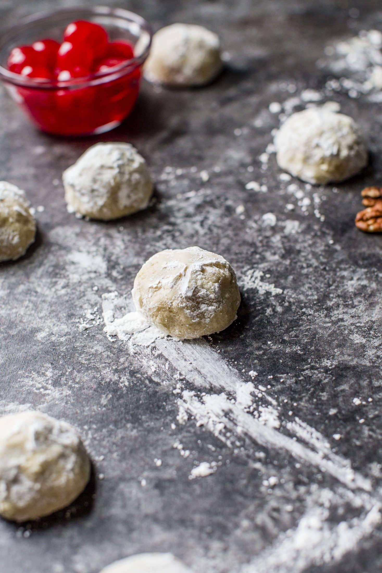 These classic butterball cookies are a favorite that my grandmother made every year at Christmas. They are a light cookie that isn't super sweet and the center is filled with either a pecan or maraschino cherry. Classic and delicious! I howsweeteats.com #butterball #cookies