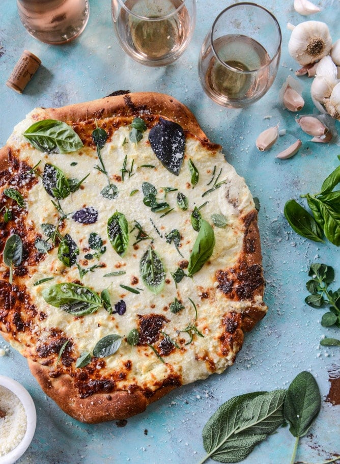 white pizza with garlic sauce and garden herbs I howsweeteats.com