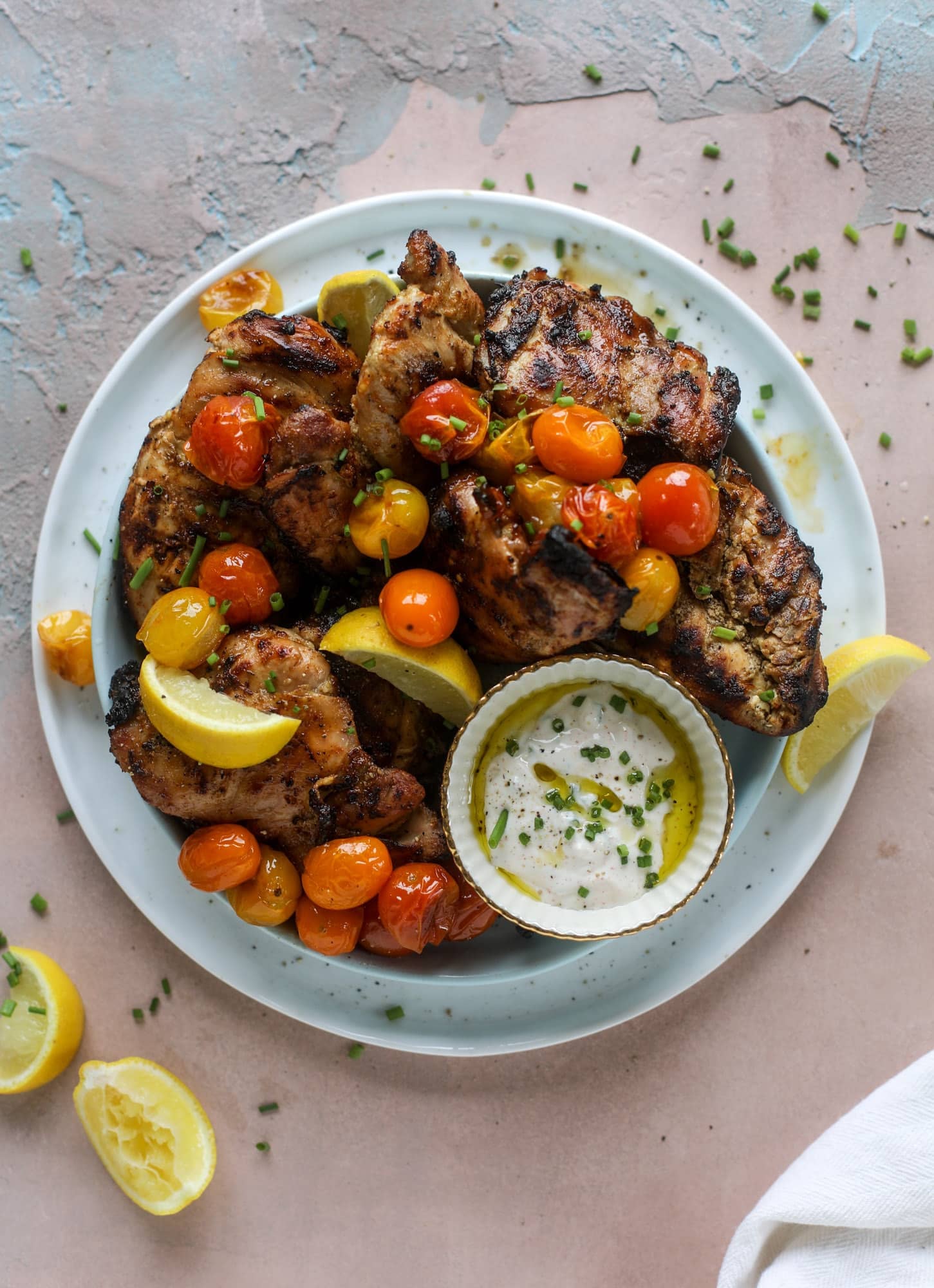 This yogurt marinated chicken recipe is super flavorful, tender, juicy and delicious. The fresh lemon adds a kick of flavor and it's a versatile recipe you can make for lunch or dinner. Grill it and serve with your favorite side, then use the leftovers for lunch! I howsweeteats.com #yogurt #chicken #lemon #grilled #healthy #recipes