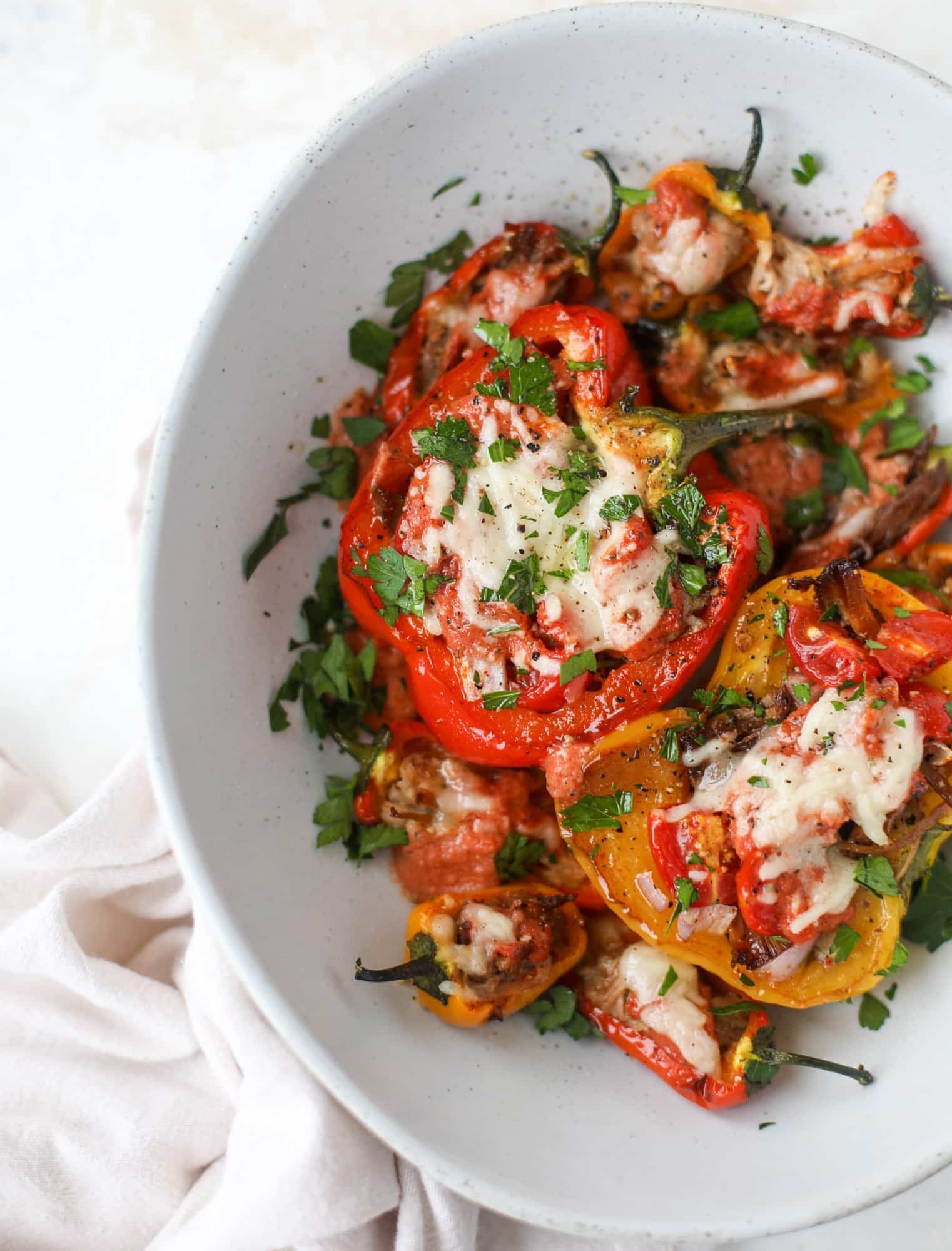 These pulled pork stuffed peppers are a delicious dinner idea for any weeknight! They work great with leftover pulled pork and the filling is totally customizable. They are flavorful, come together quickly and always a crowd pleaser! I howsweeteats.com #pulledpork #stuffedpeppers