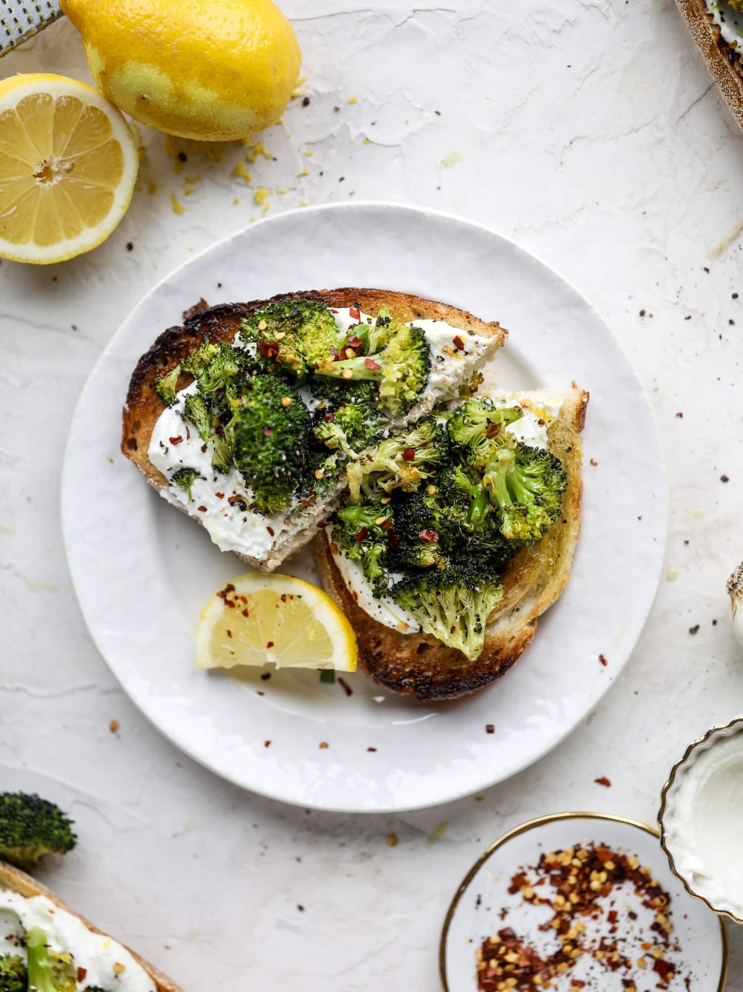 Broccoli toast is the best way to sneak in some veggies! Toasted sourdough with ricotta and roasted broccoli, topped with lemon and crushed red pepper. 