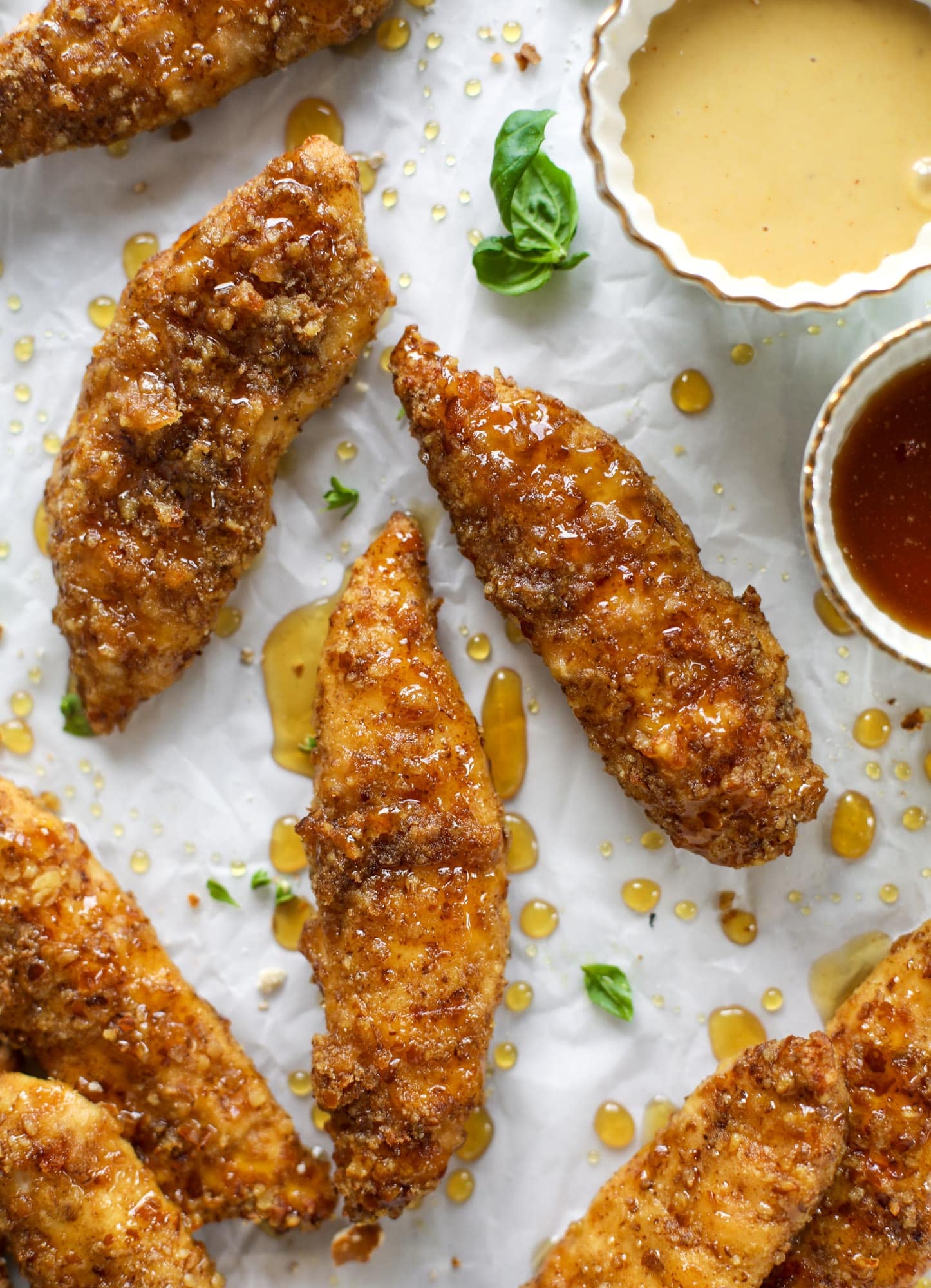 These pretzel crusted chicken fingers are baked, crunchy and ridiculously flavorful. Drizzle with hot honey and dip in house sauce. Yum!