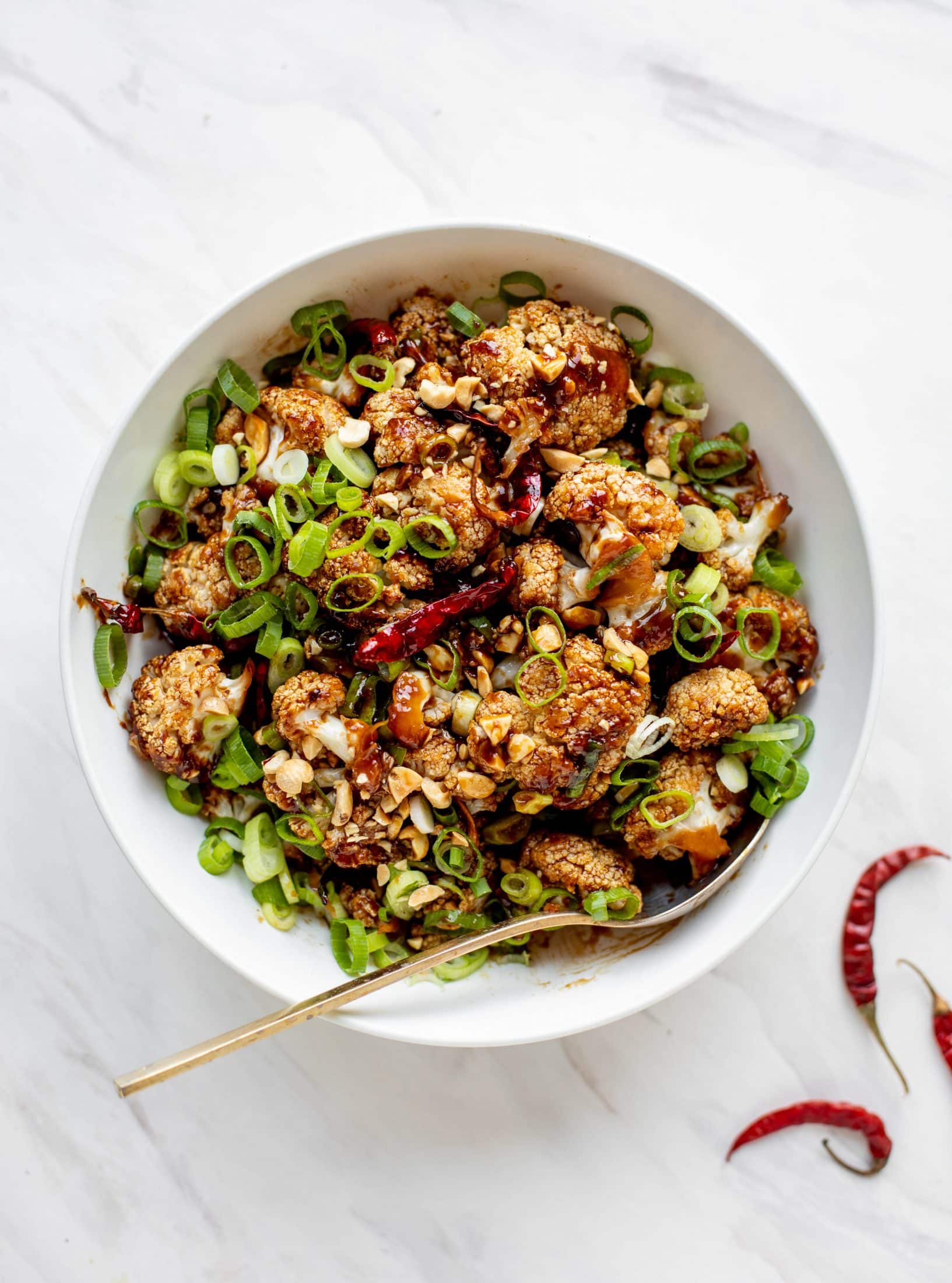 This kung pao cauliflower recipe is roasted on one sheet pan and covered in a delicious sauce! Serve alongside jasmine rice for the best dinner ever.