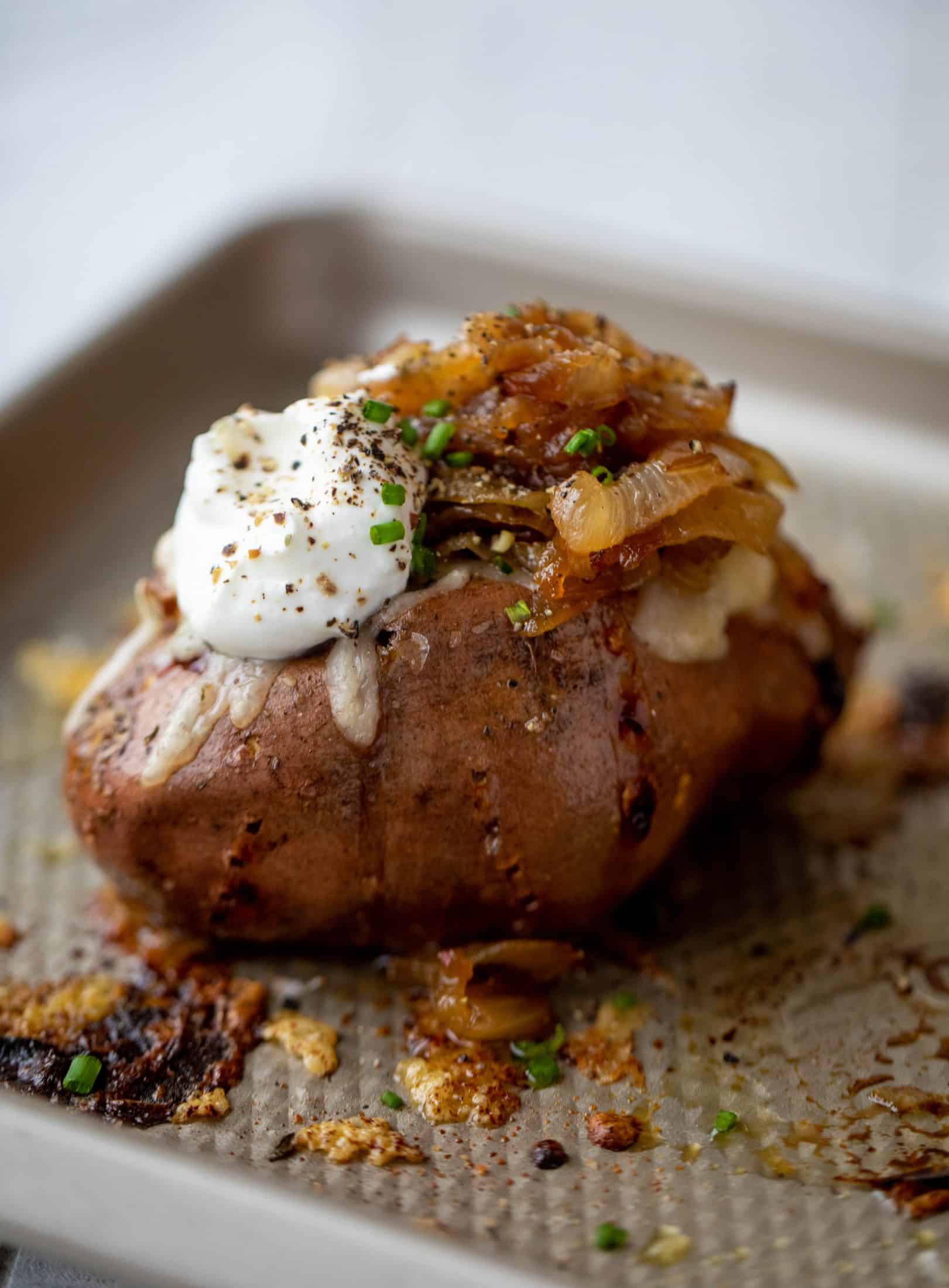 These french onion stuffed sweet potatoes are slow roasted and topped with gruyere cheese and caramelized onions. Garlic butter bread crumbs finish them!