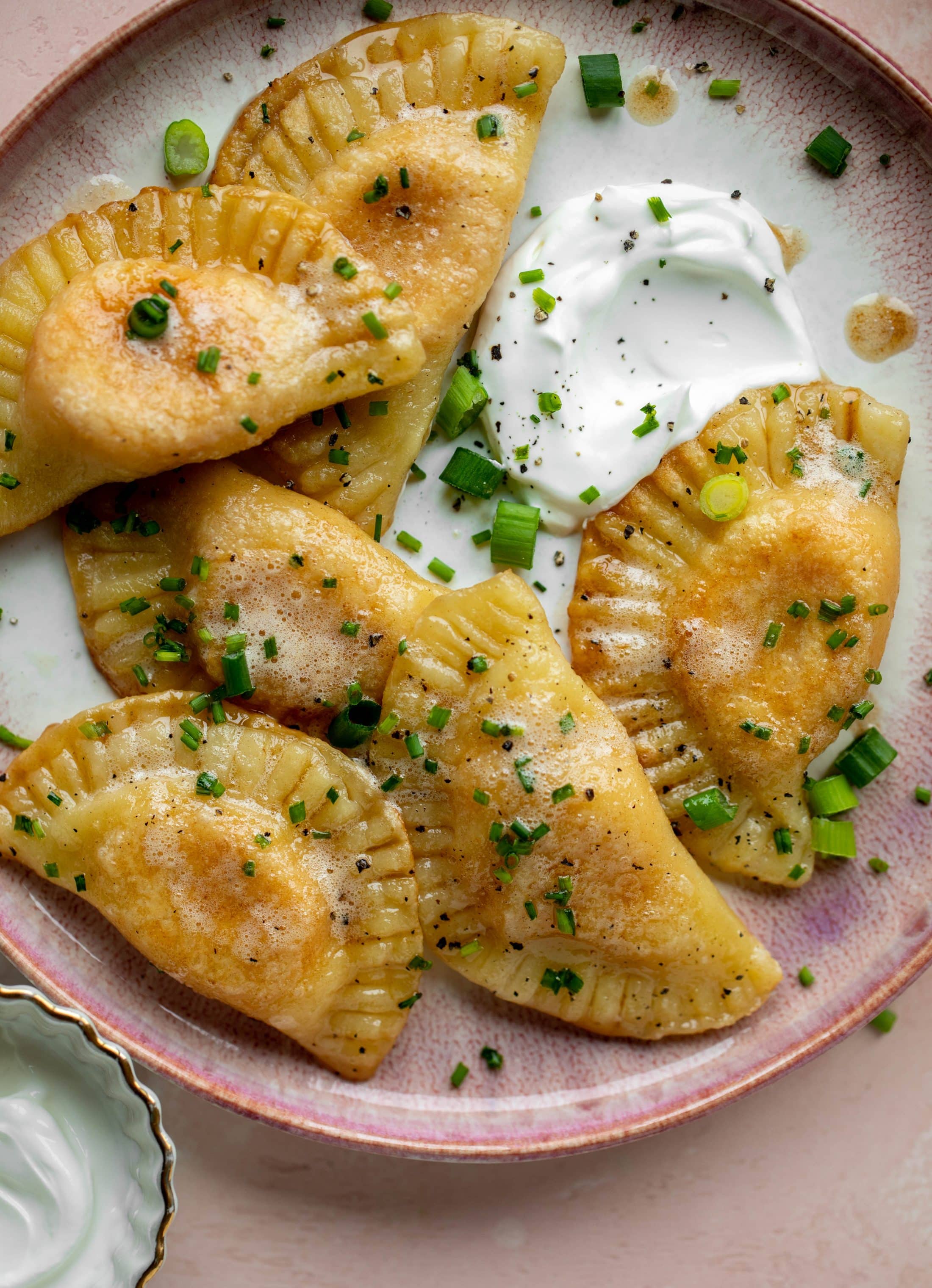 The most delicious sweet potato pierogi recipe! Roasted sweet potato and fontina cheese in pillowy dough. Make sure to serve with brown butter!
